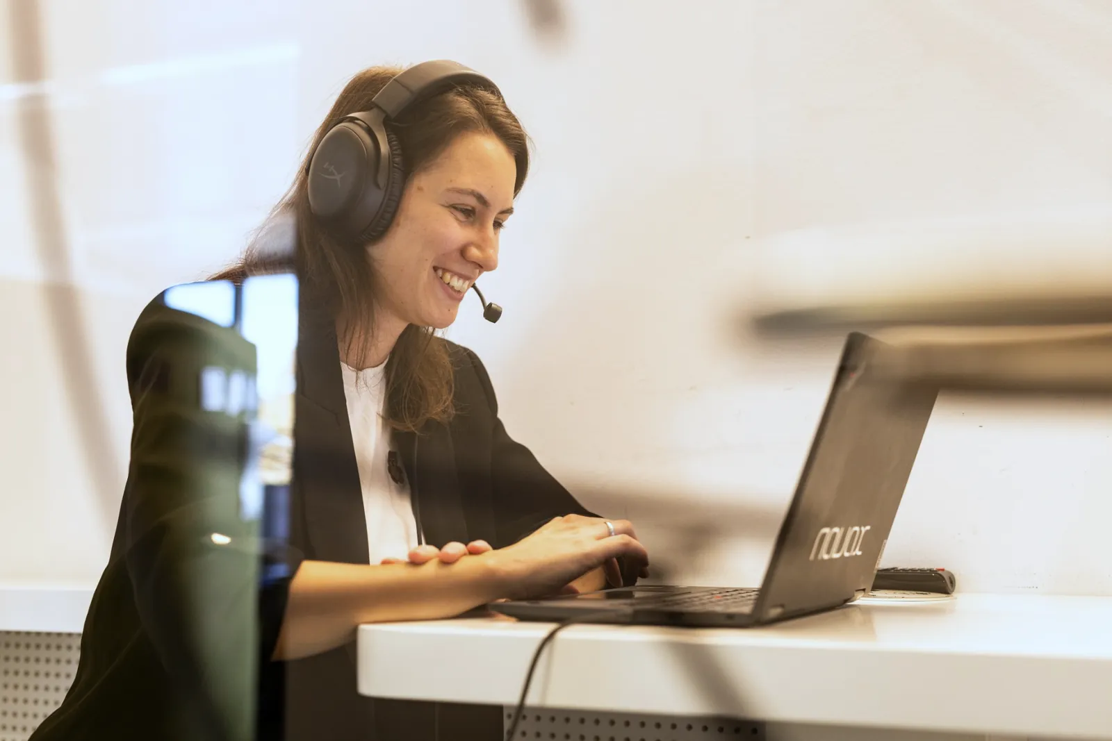 Employee with a headset working at a laptop