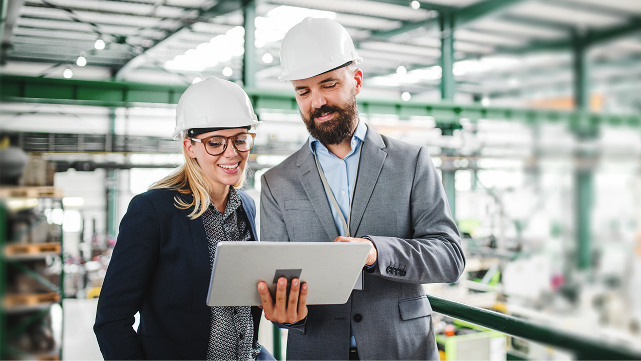 Business partners discuss current figures on a tablet and plan measures